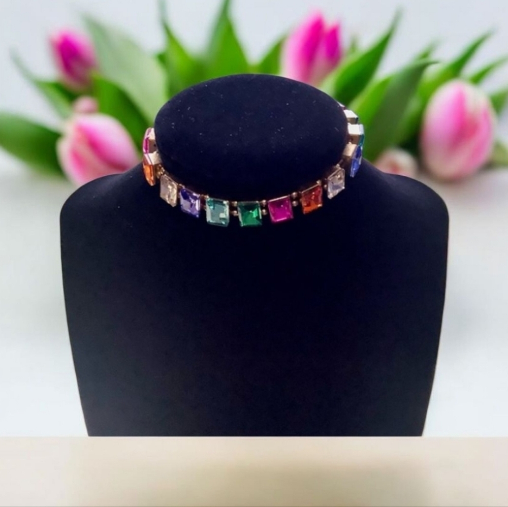 Bracelet with colored stones Stretchy gold tone background size large.
